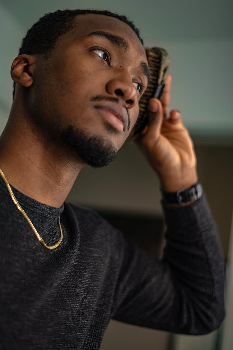 Portrait Of A Man Brushing His Hair