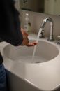 Person Washing Hand on Sink