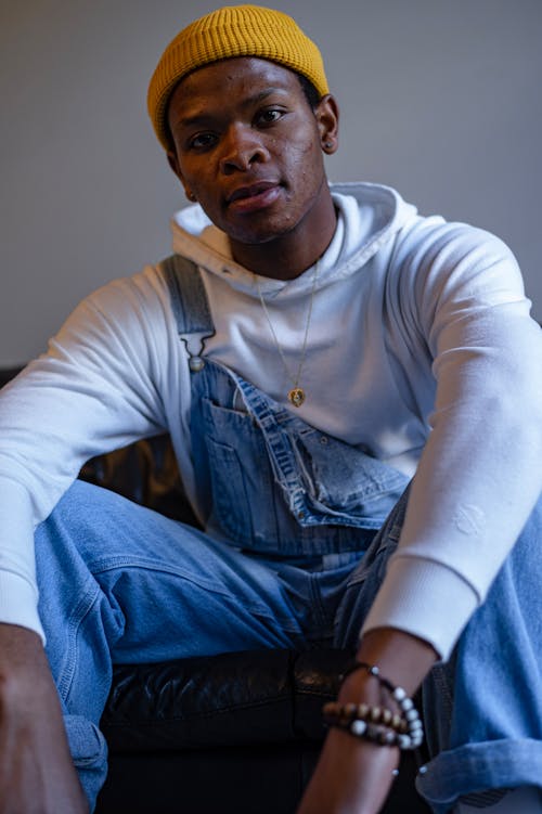 Portrait of a Man in a White Hoodie and Denim Dungarees 