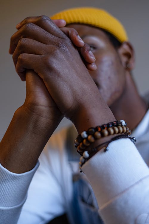 Unrecognizable Man in Yellow Knitted Hat with Wooden Bracelet