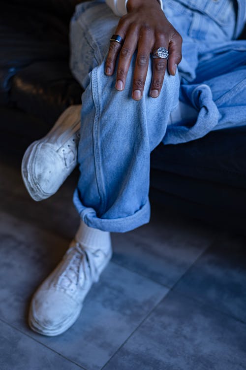 Free Close-Up Shot of a Person Wearing Blue Denim Pants and White Shoes Stock Photo