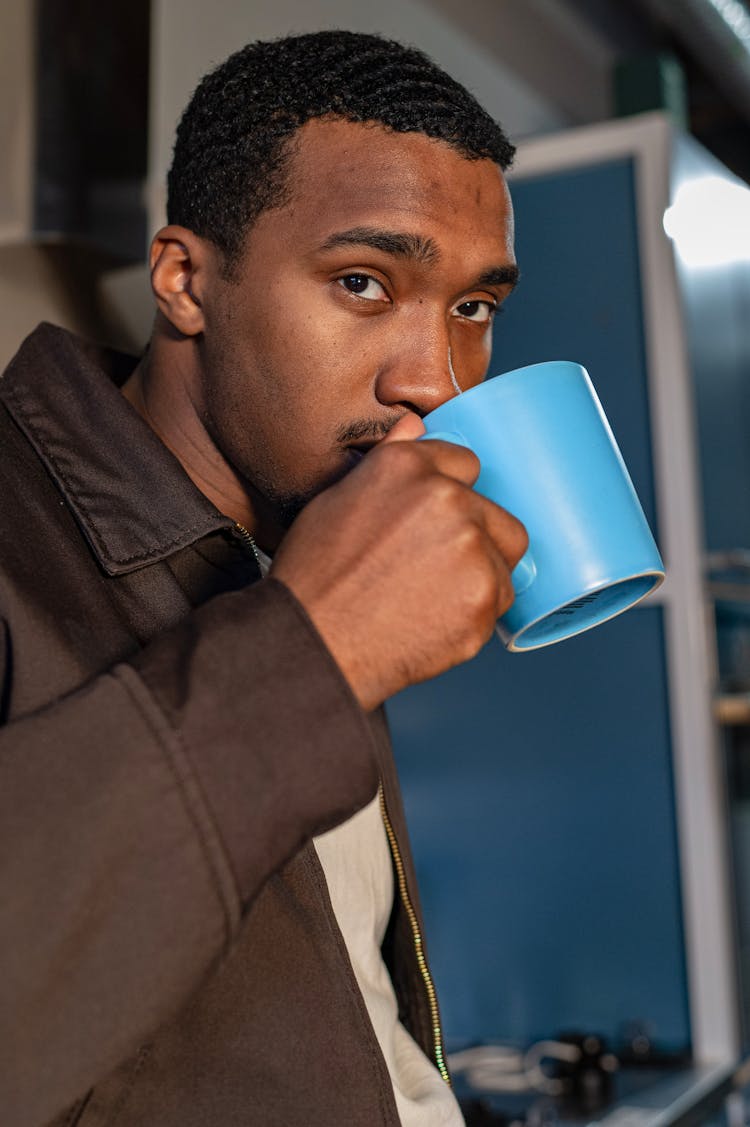 Close-Up Shot Of A Man Holding A Blue Coffee Mug