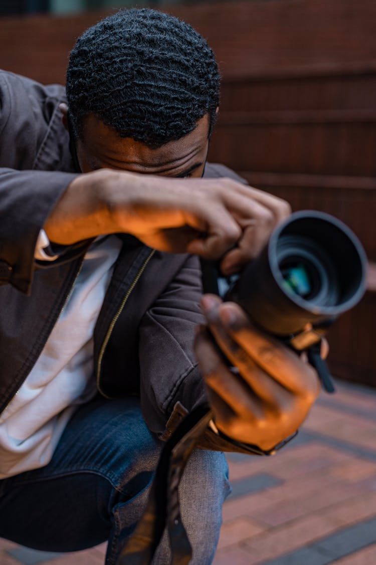 Man In Black Blazer Holding Black DSLR Camera