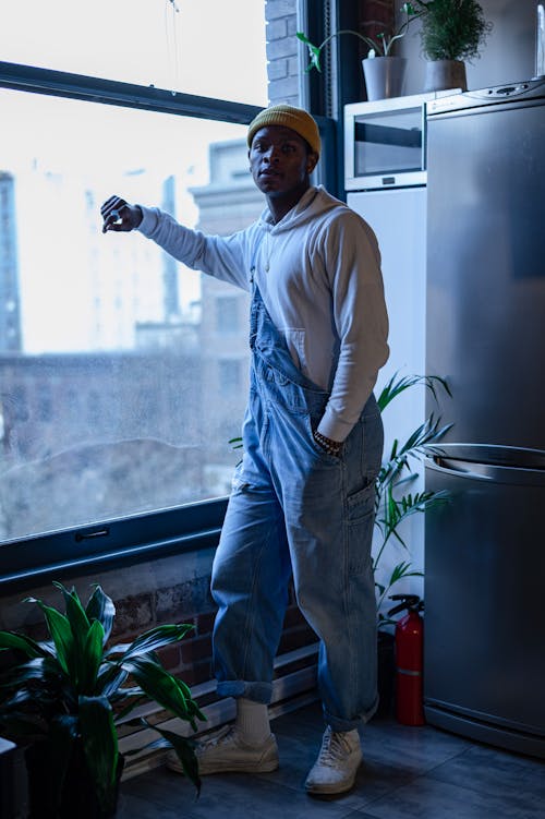 Stylish Person Standing Near Glass Window