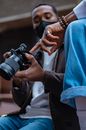 Person in Blue Denim Jeans Holding Black Dslr Camera