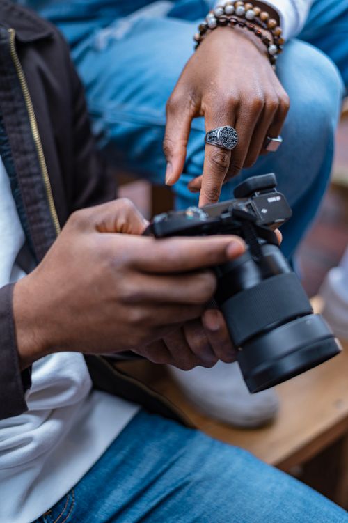 Free Detailed view of hands examining a camera, showcasing photography enthusiasm. Stock Photo