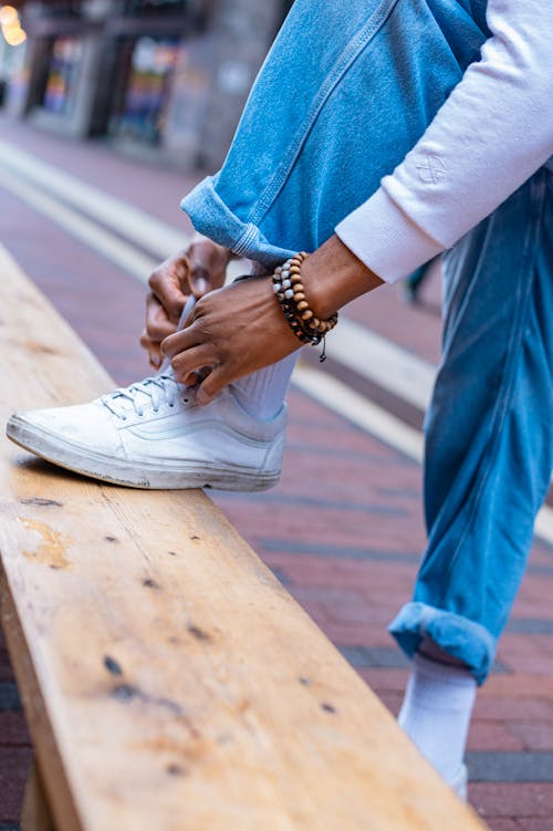 Person in Black and White Sneakers Tying Laces · Free Stock Photo