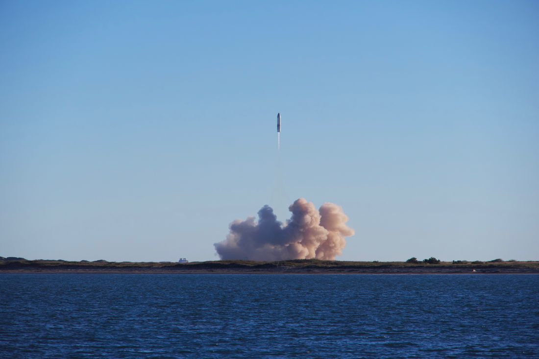 A rocket launch with smoke trails over a coastline — photo by Forest Katsch on Pexels