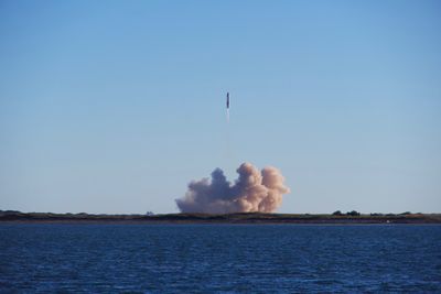 A launch vehicle rising over the coast at dusk — photo by Forest Katsch on Pexels