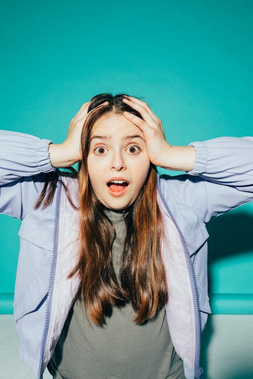 Free Shocked Girl With her Hands on her Head Stock Photo