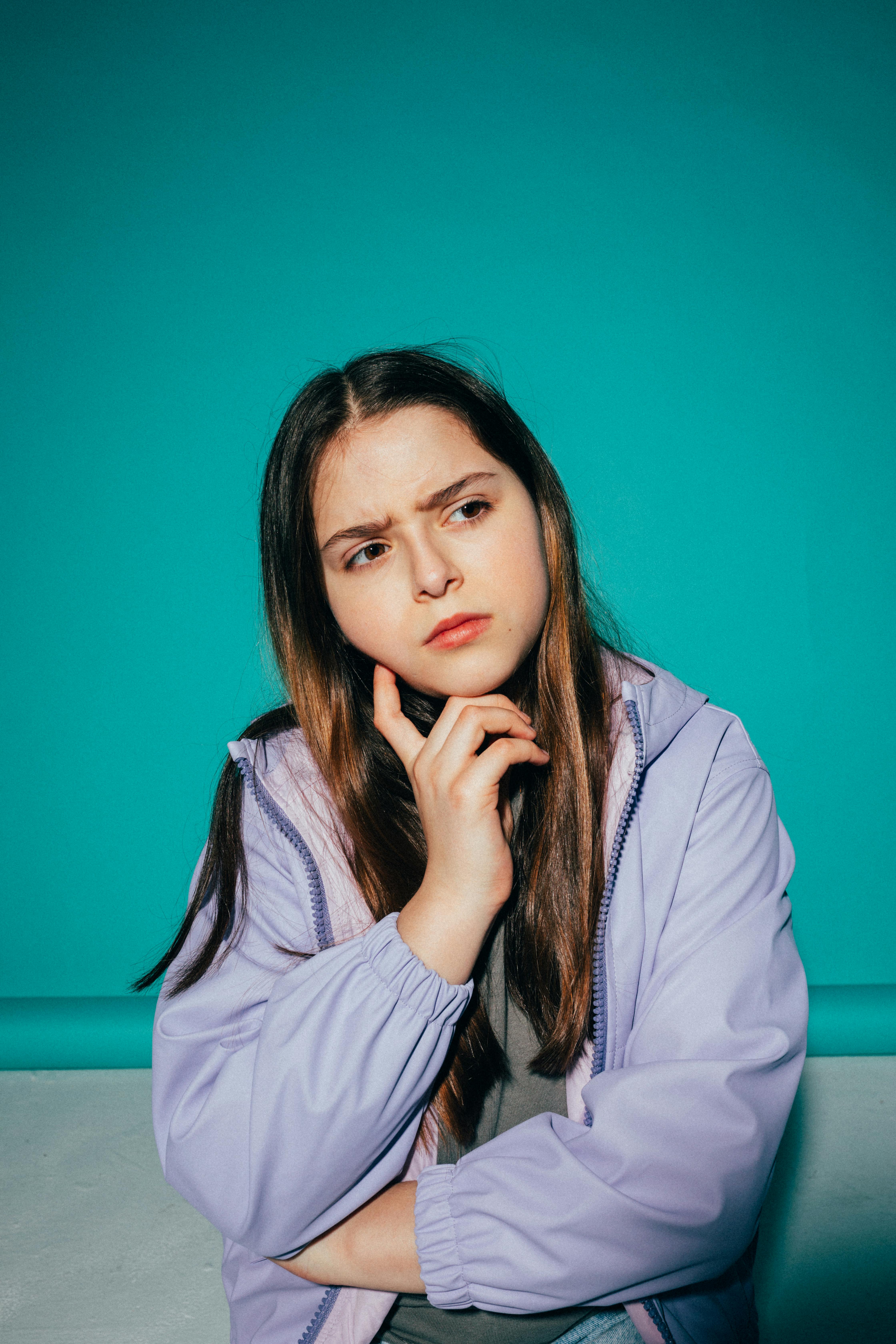 girl wearing a jacket thinking