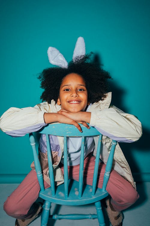 Smiling Girl Sitting on a Chair