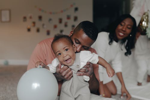 A Man Kissing a Child