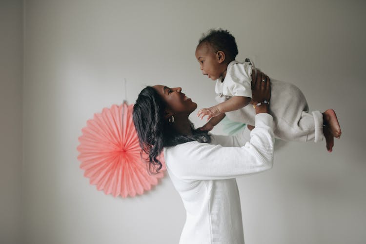 Woman Lifting A Toddler