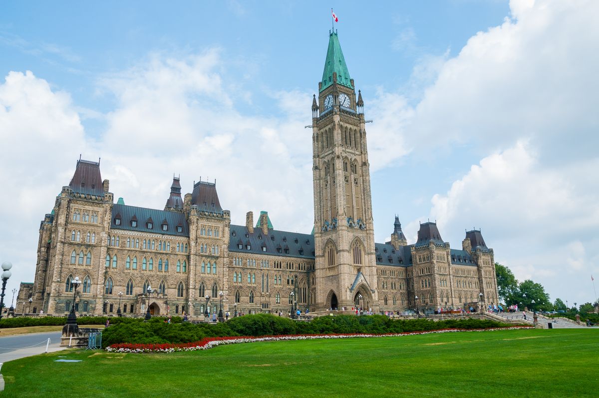 Parliament Hill's Gothic Revival towers in Ottawa under a clear sky
