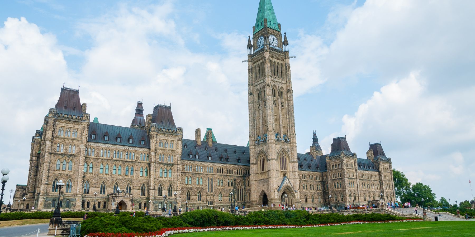 Stunning photo of Canada's Parliament Hill in Ottawa under a clear sky, showcasing Gothic Revival architecture.