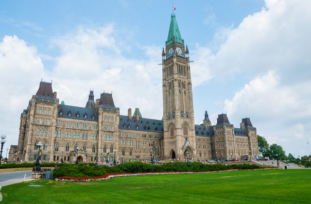 Stunning photo of Canada's Parliament Hill in Ottawa under a clear sky, showcasing Gothic Revival architecture. — arriving in Ottawa