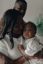 Woman in White and Black Striped Shirt Carrying Baby in White Shirt