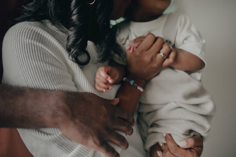 Man Hand Embracing Woman And Child