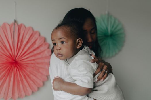 Man in White Dress Shirt Carrying Baby in White Dress