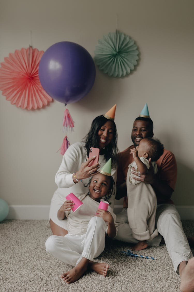 A Family Sitting On The Floor