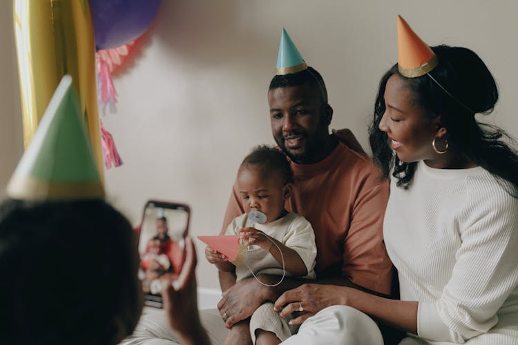 Man And A Woman Wearing Party Hats