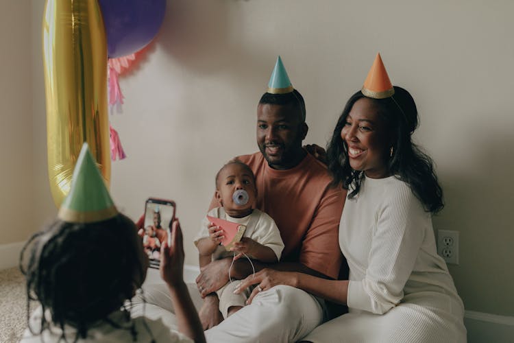 Man And A Woman Wearing Party Hats