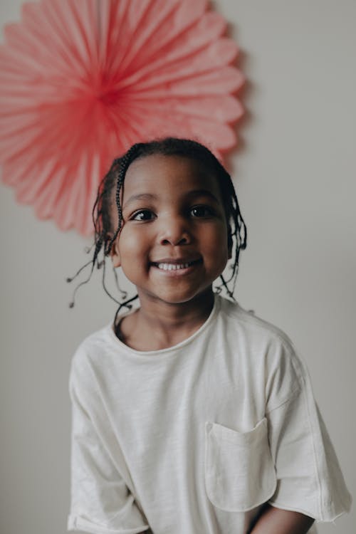 Smiling Child with Brunette Braided Hair