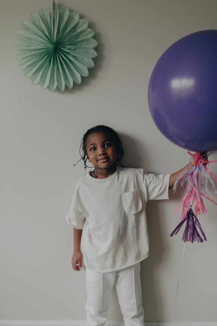 Girl Holding A Purple Balloon