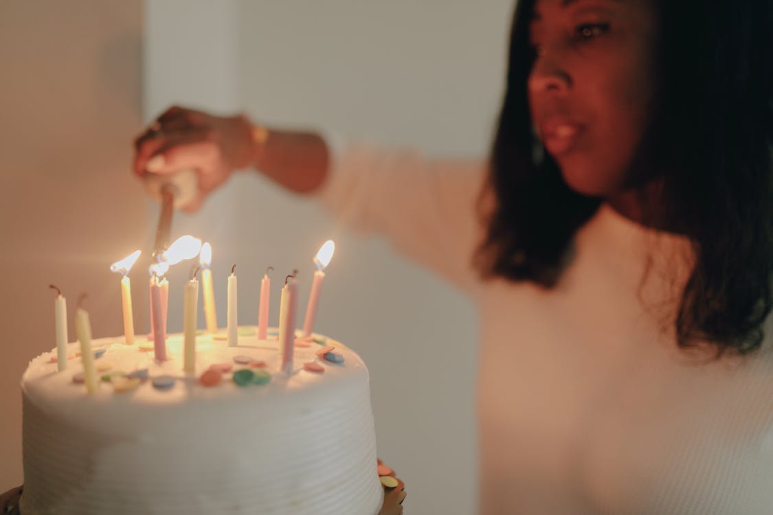Shallow Focus of a Woman Lighting the Birthday Cake Candles · Free ...