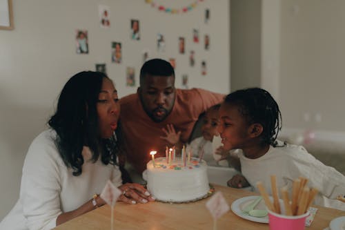 People Blowing Candles