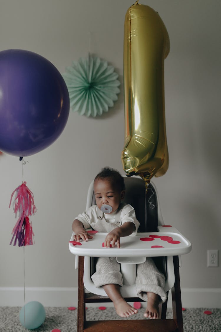 Baby Sitting On His High Chair