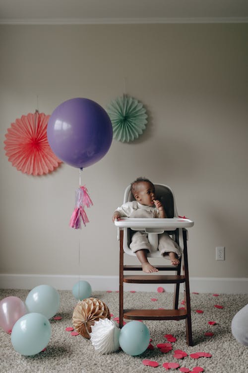 Free Baby Sitting on a High Chair  Stock Photo