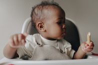 Baby Holding a Biscuit