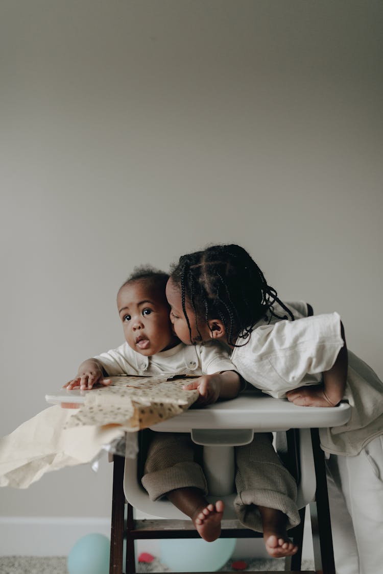 Boy Kissing A Toddler