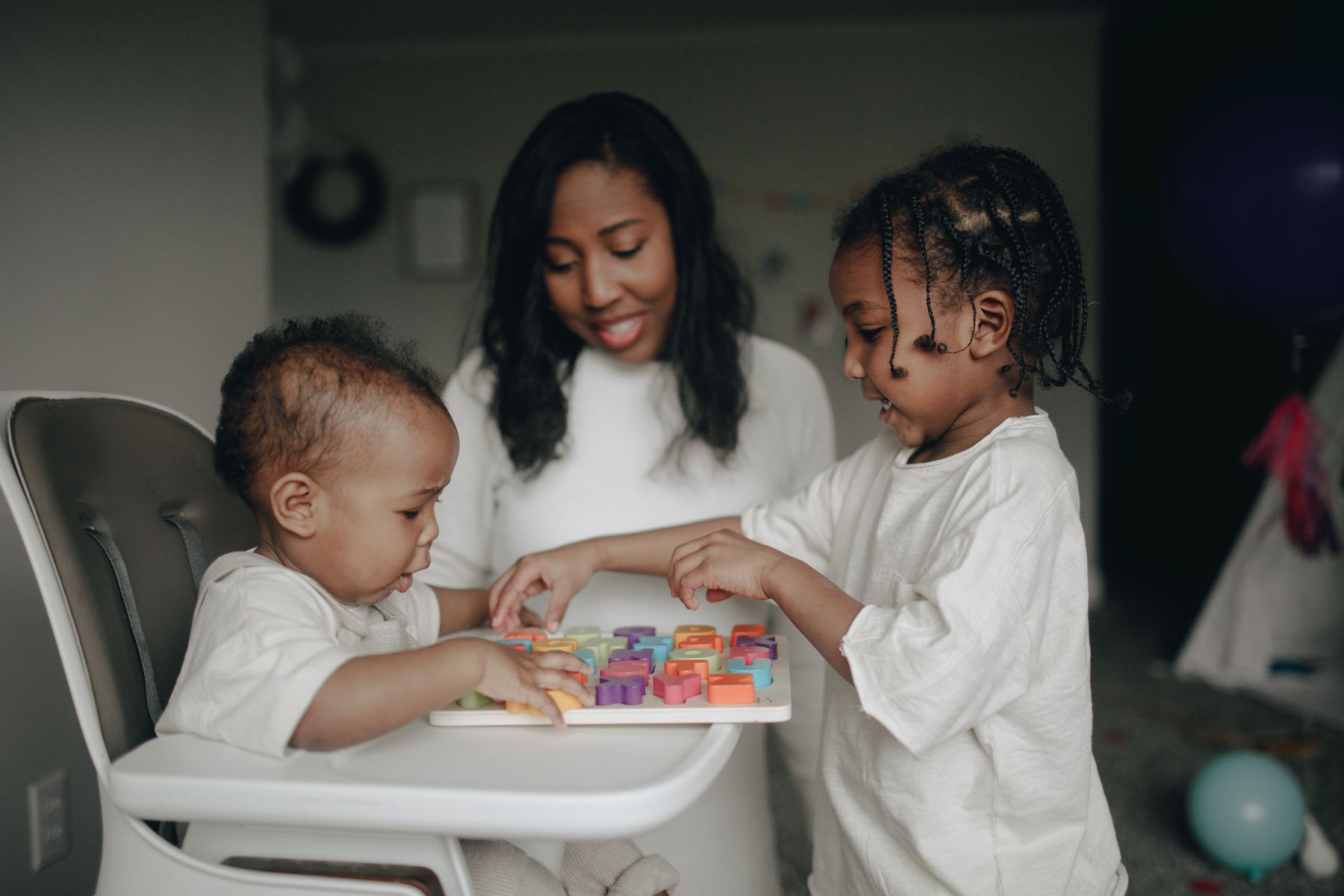 Family enjoying creative play together with colorful building blocks at home