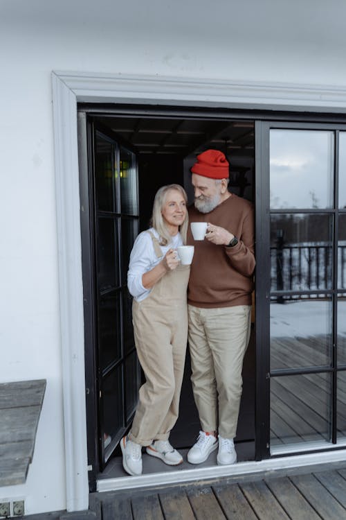 Free Man and Woman Standing by the Door Stock Photo