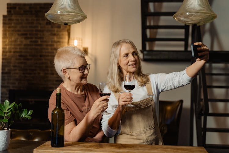 Women Holding Wine Glasses