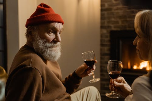 Free Man in Brown Sweater Holding a Wine Glass Stock Photo