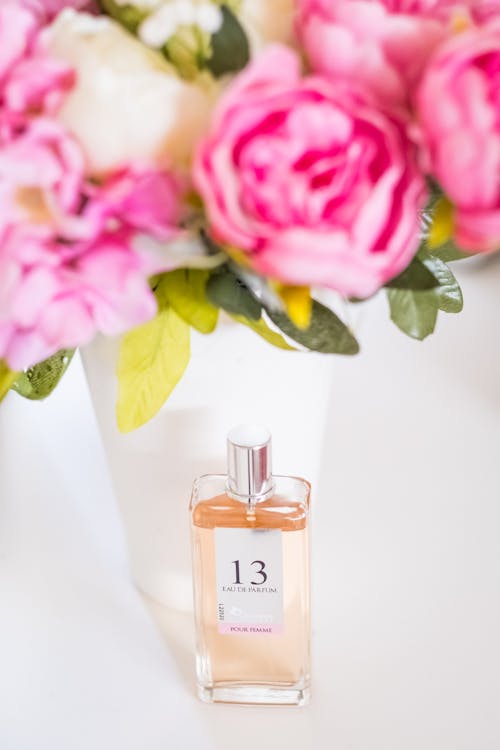 Free Pink Rose Beside Perfume Bottle Stock Photo