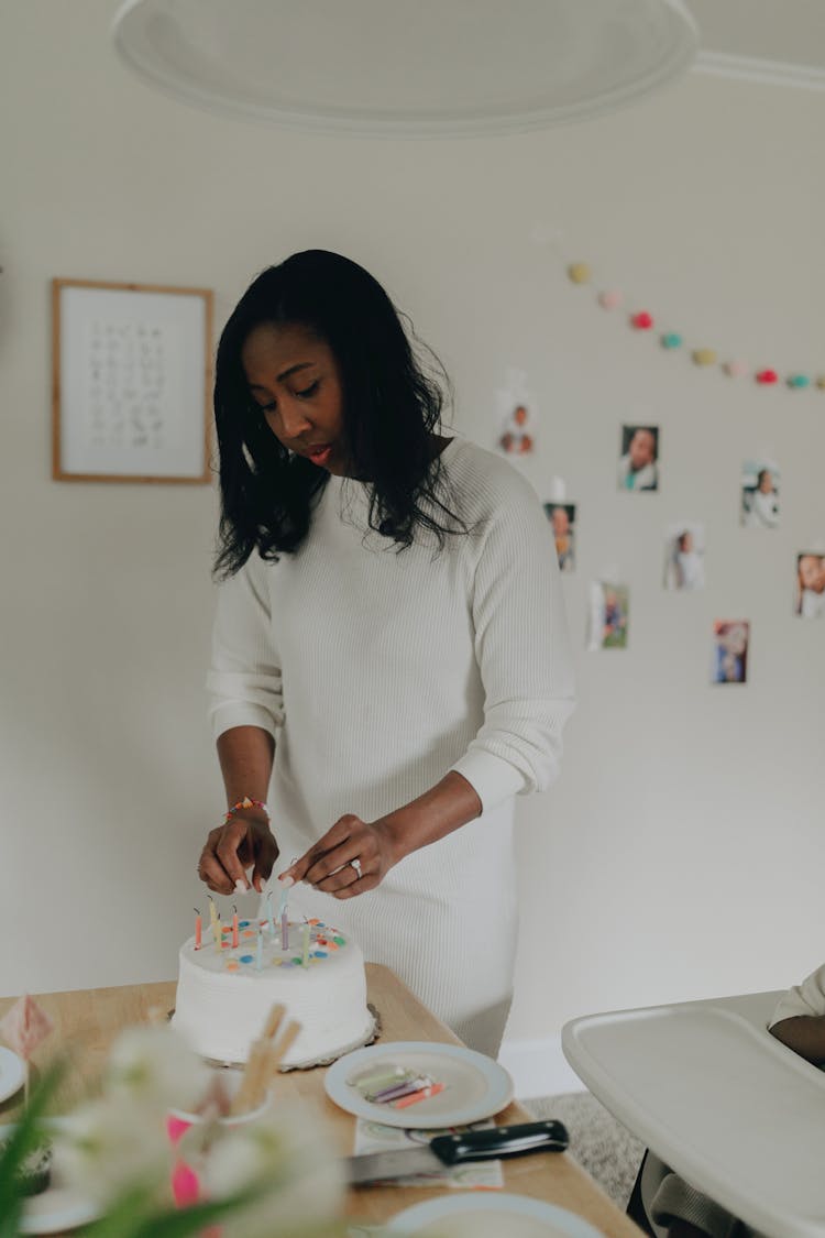 A Woman Removing Candles From The Cake