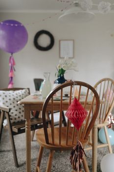 Cozy indoors with festive decorations and wooden furniture setup for a birthday celebration.