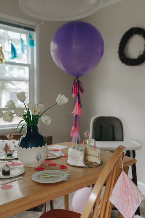 Free Beautifully decorated birthday table with a cake, balloons, and festive ambiance. Stock Photo