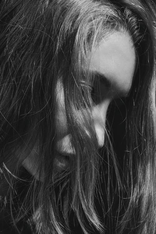 Grayscale Photo of Woman Covered Face With Her Hair 