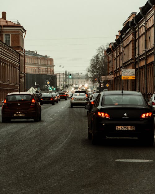 Cars on Road Under Gray Sky