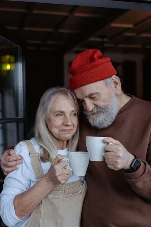 Free Man and Woman Holding White Mugs Stock Photo