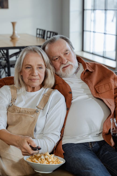 Woman in White Long Shirt Sitting Beside Man 