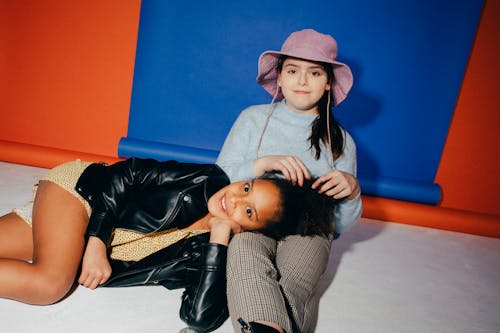 Girl Wearing a Black Jacket Lying Down on Another Girl's Lap