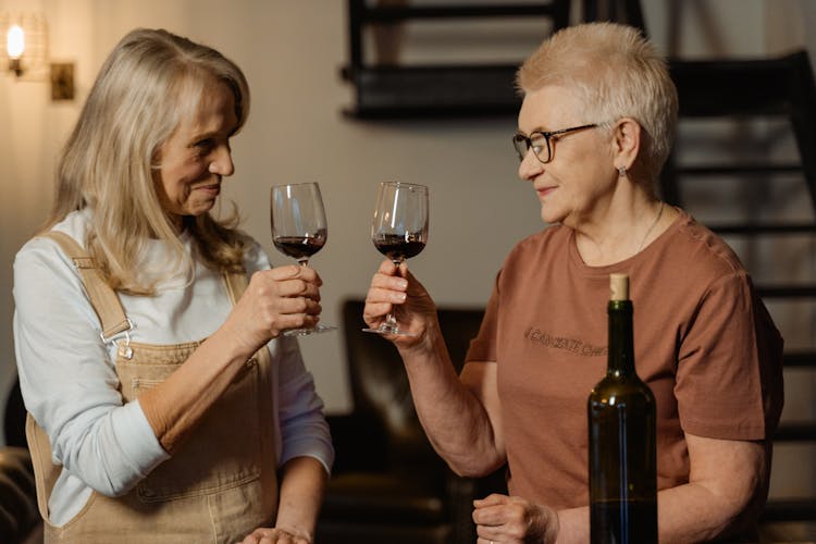 Women Holding Wine Glasses