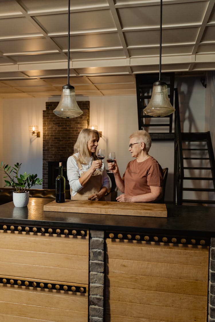 Women Holding Wine Glasses